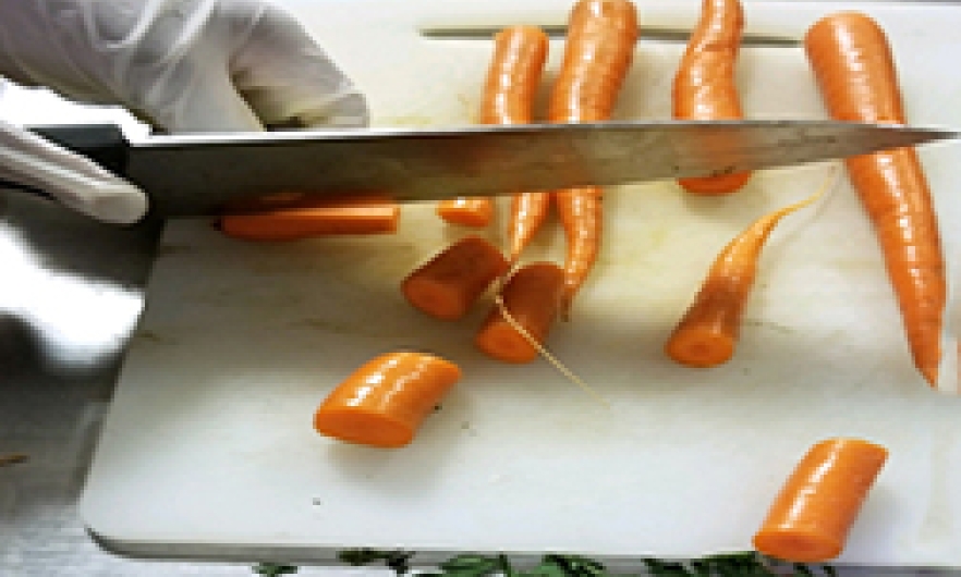 A student slicing carrots
