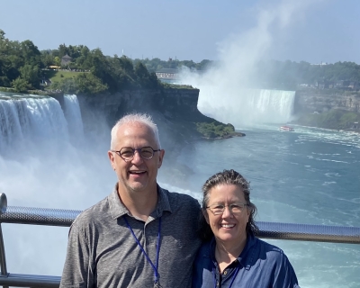 Eileen McDonald and husband David on a boat with Niagara Falls in the background