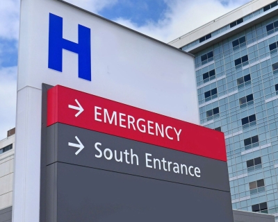 Outdoor sign that reads Emergency and South Entrance