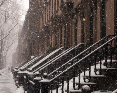 Brownstone rowhomes in light snowfall