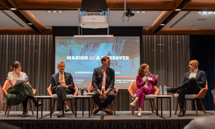 Biostatistician Elizabeth Stuart (in purple) makes a point to HHS assistant secretary Micky Tripathi; other AI event panelists (l to r): Alison Snyder, John Auerbach, and Jesse Ehrenfeld. 