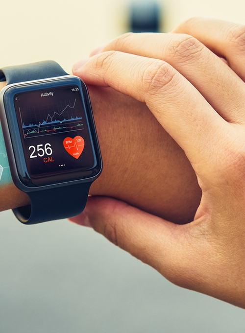 woman looking at her smart watch, seeing metrics